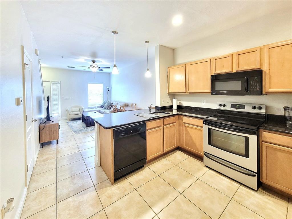 2946 Southwest 35th Place, Unit 44 Gainesville, FL 32608 - Photo 10 of 25 a kitchen with stainless steel appliances granite countertop a sink and cabinets