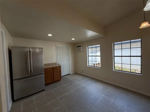 a kitchen with stainless steel appliances a refrigerator and a window