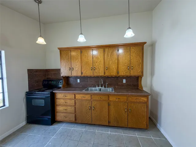 a kitchen with a sink and a refrigerator