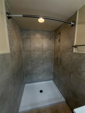 a bathroom with a shower and toilet