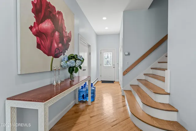 a view of entryway and hall with wooden floor