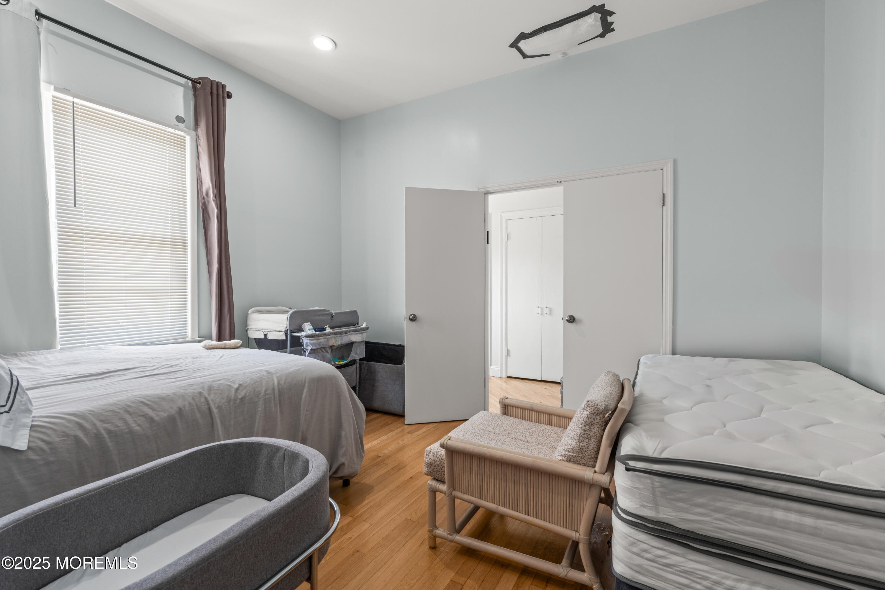 460 Runyan Avenue Deal, NJ 07723 - Photo 10 of 11 a bedroom with a bed and a couch