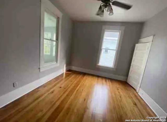 a bathroom with a granite countertop bathtub sink vanity mirror and toilet