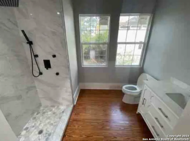 a bathroom with a sink toilet and shower