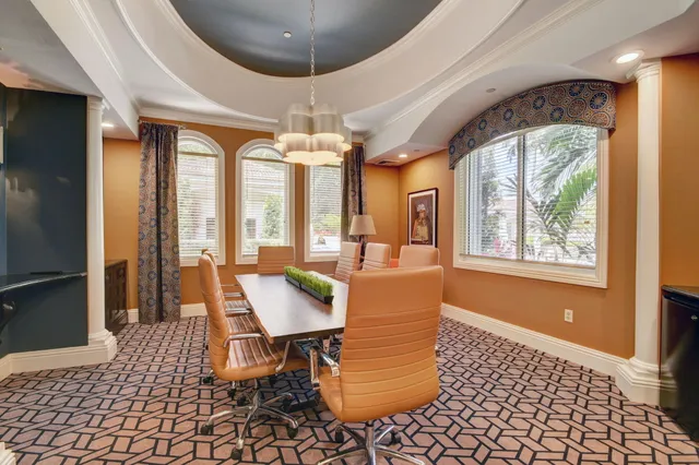 a room with pool table and wooden floor