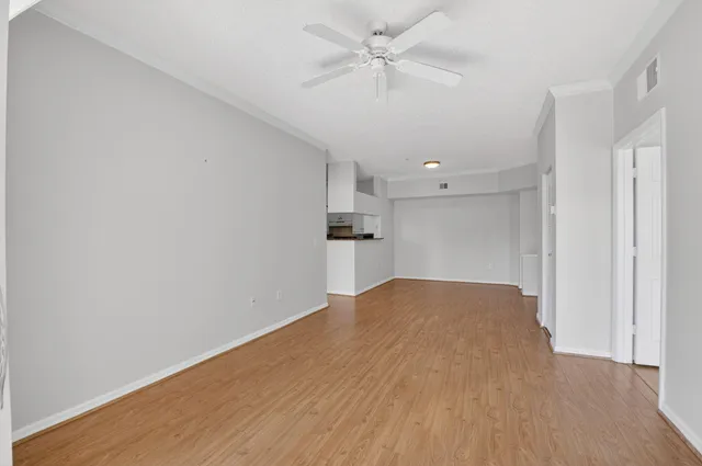 a kitchen with granite countertop white cabinets and a sink