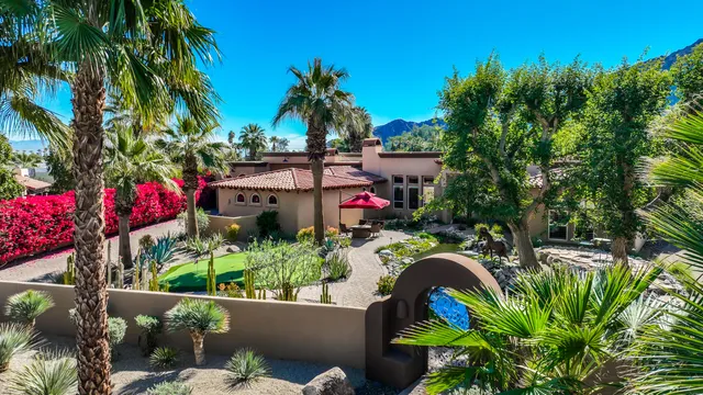 a view of a swimming pool with a table and chairs