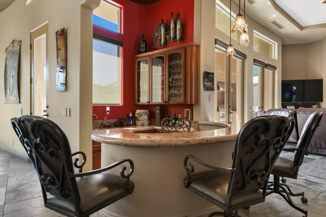 a dining room with furniture a rug and a chandelier