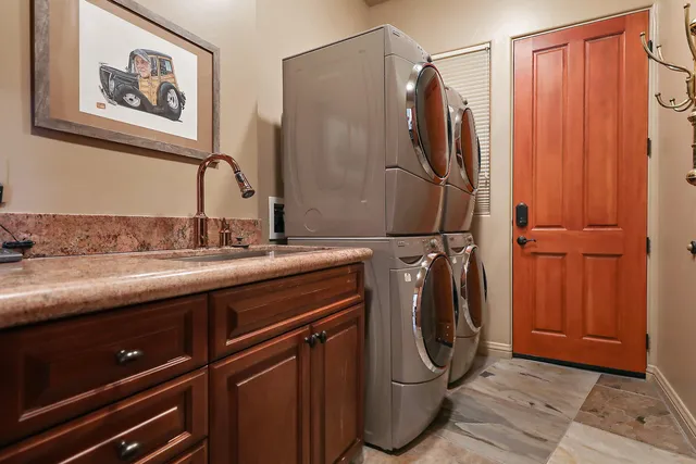 a bathroom with a granite countertop sink a toilet and a mirror