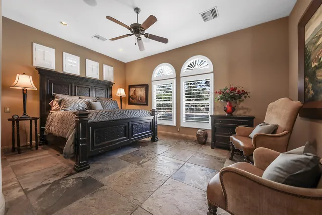 a bathroom with a granite countertop sink a toilet and a mirror