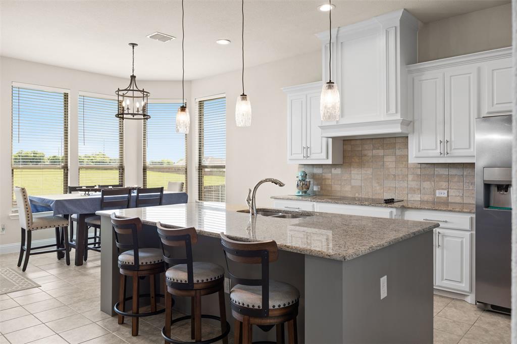 2618 Byrd Ranch Road Midlothian, TX 76065 - Photo 15 of 38 a kitchen with granite countertop a sink a center island and some cabinets