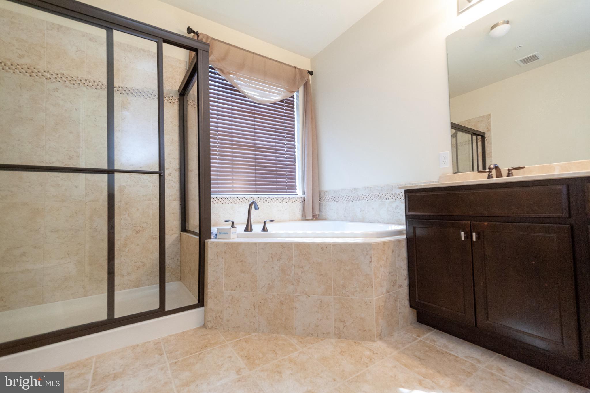 4514 Champions Run, Unit 4514 Cherry Hill, NJ 08002 - Photo 12 of 16 a bathroom with a bathtub and a sink