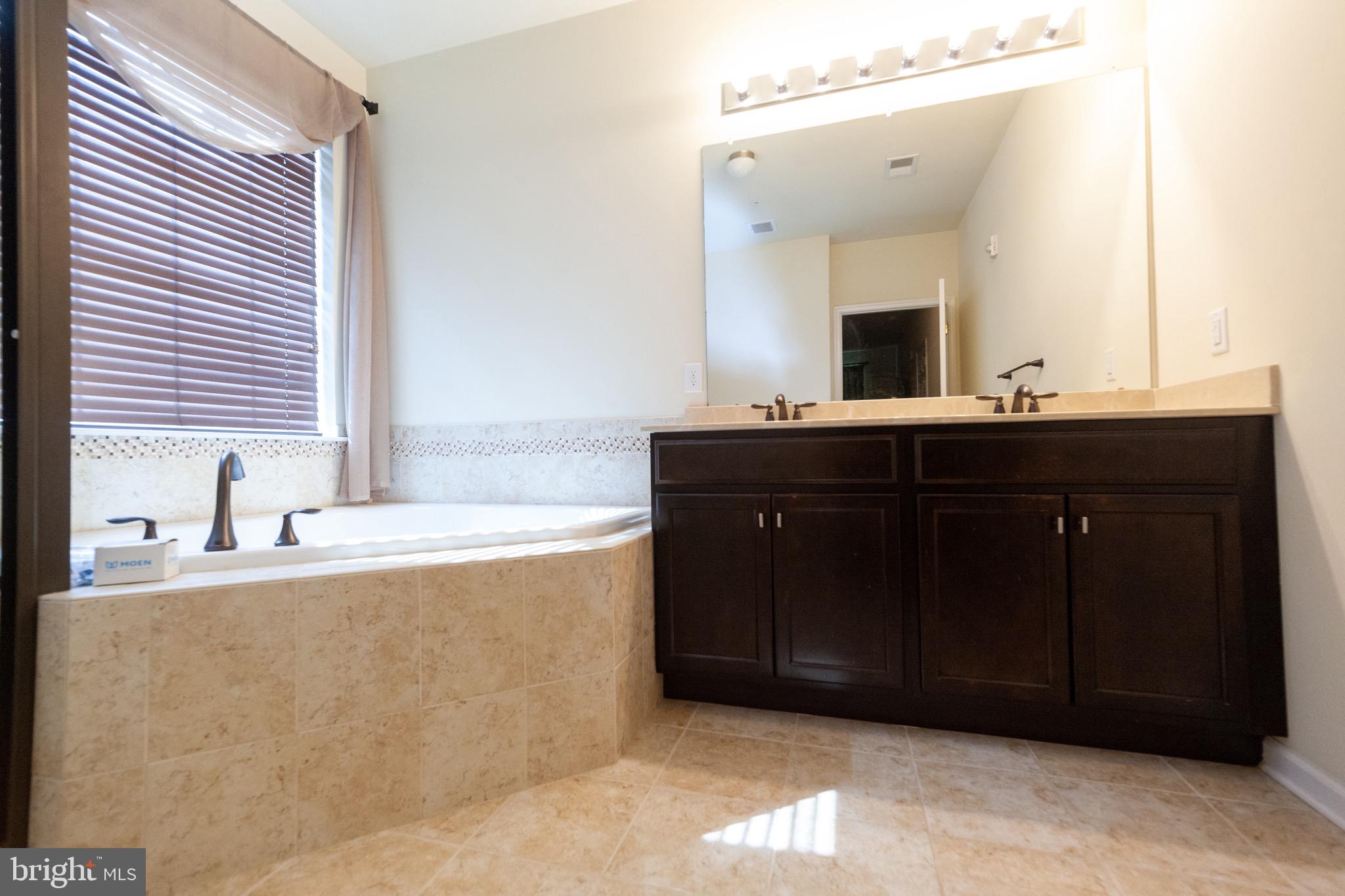 4514 Champions Run, Unit 4514 Cherry Hill, NJ 08002 - Photo 13 of 16 a bathroom with a granite countertop sink and a mirror