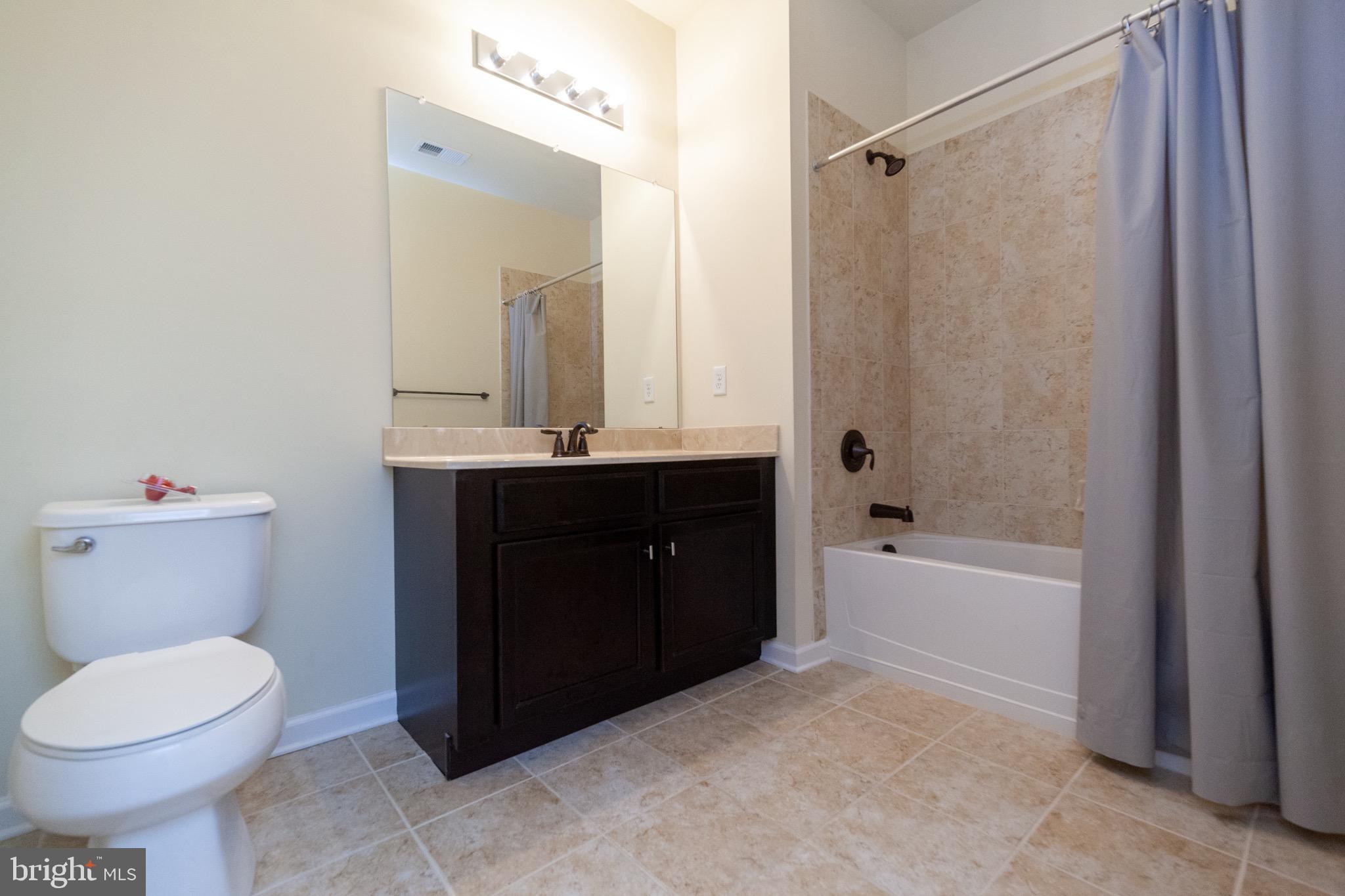 4514 Champions Run, Unit 4514 Cherry Hill, NJ 08002 - Photo 15 of 16 a bathroom with a sink a toilet and shower
