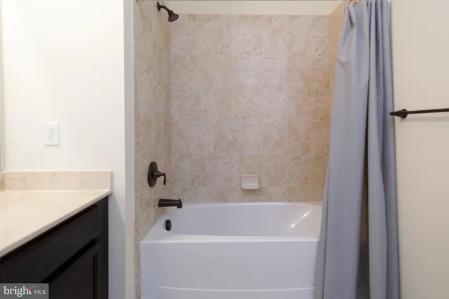 a bathroom with a bathtub and shower