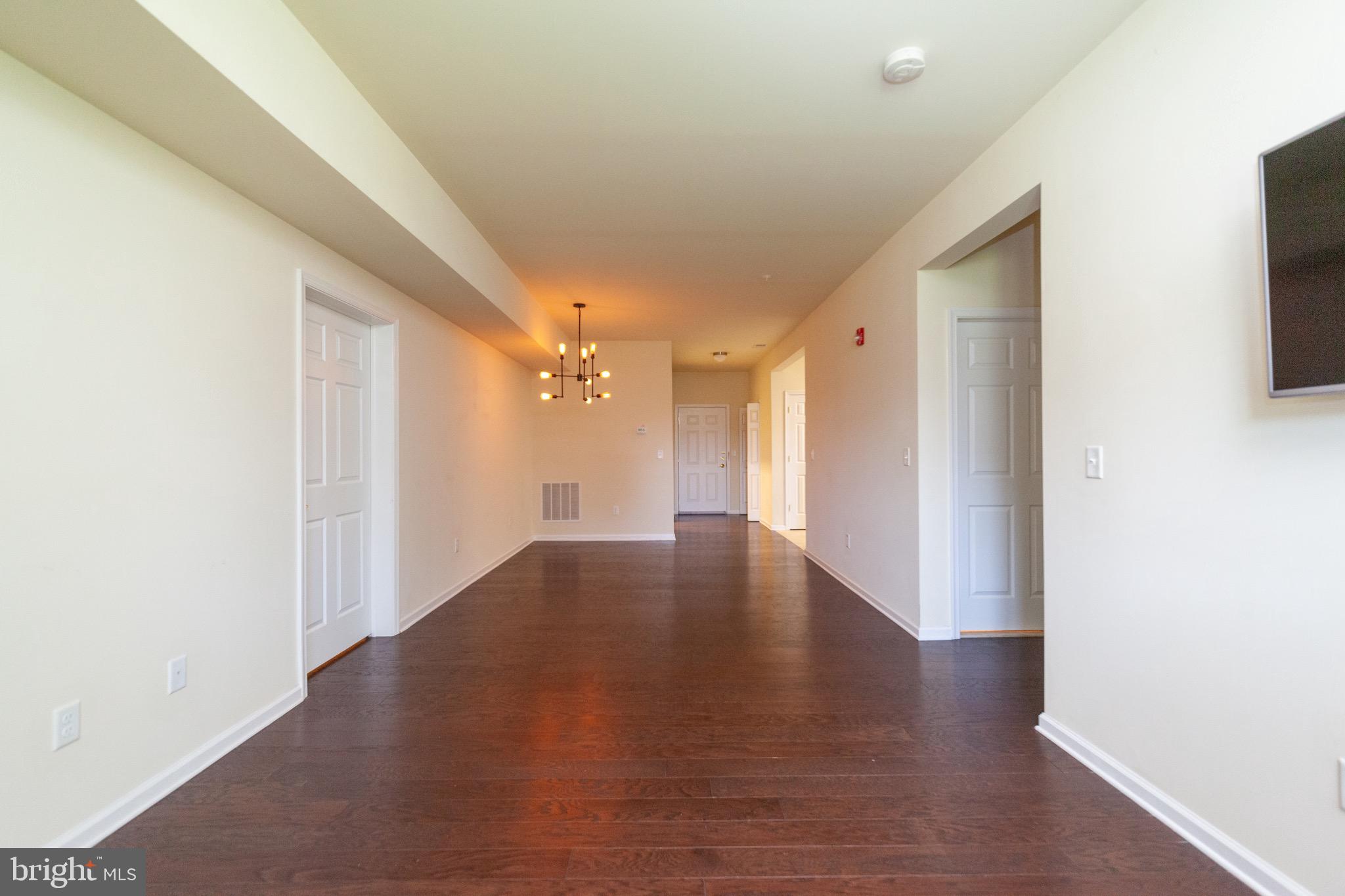 4514 Champions Run, Unit 4514 Cherry Hill, NJ 08002 - Photo 4 of 16 a view of a hallway with wooden floor