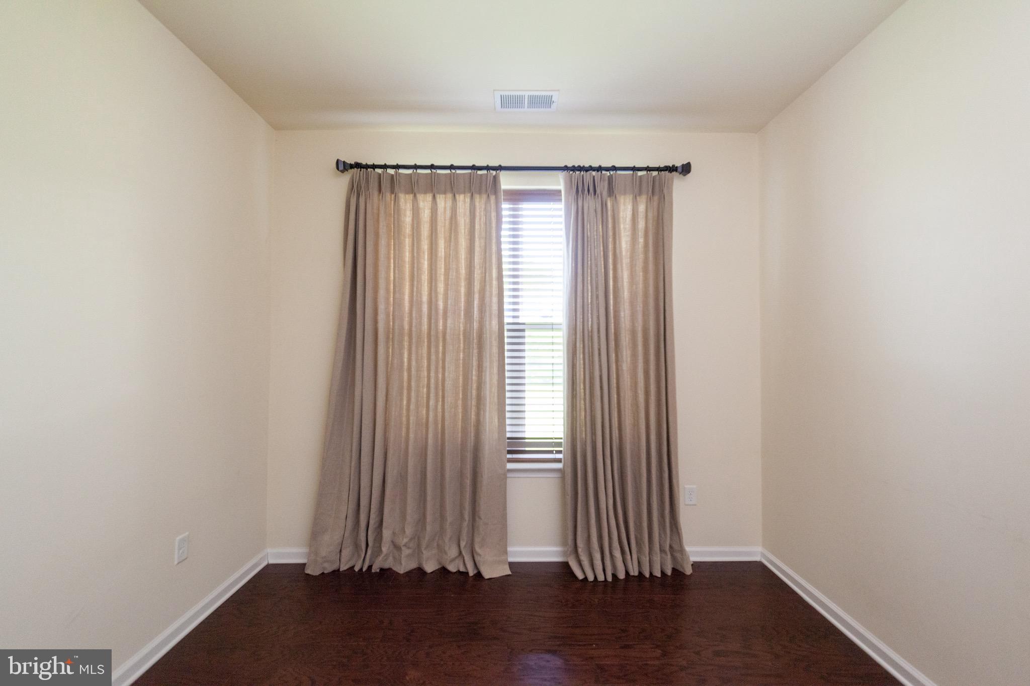 4514 Champions Run, Unit 4514 Cherry Hill, NJ 08002 - Photo 8 of 16 an empty room with wooden floor and windows