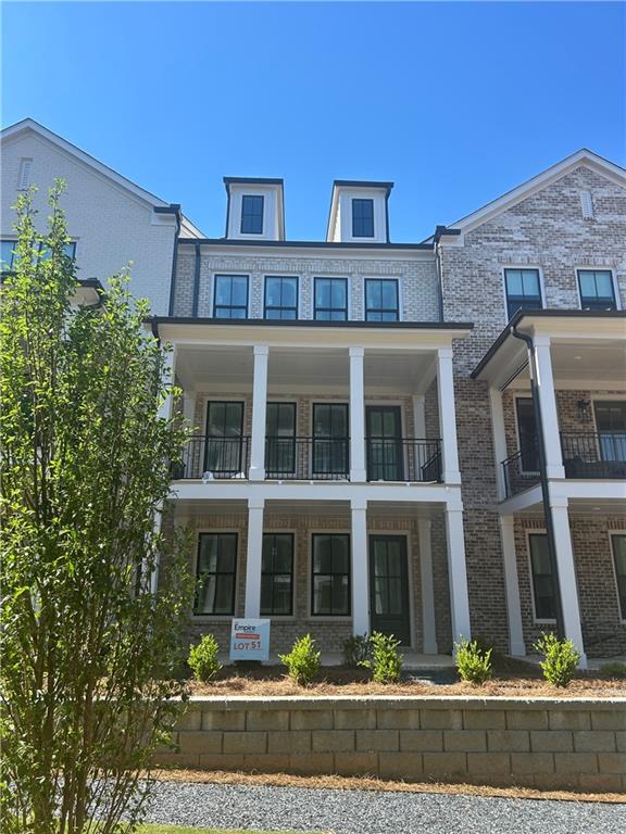 a front view of a residential apartment building with a yard