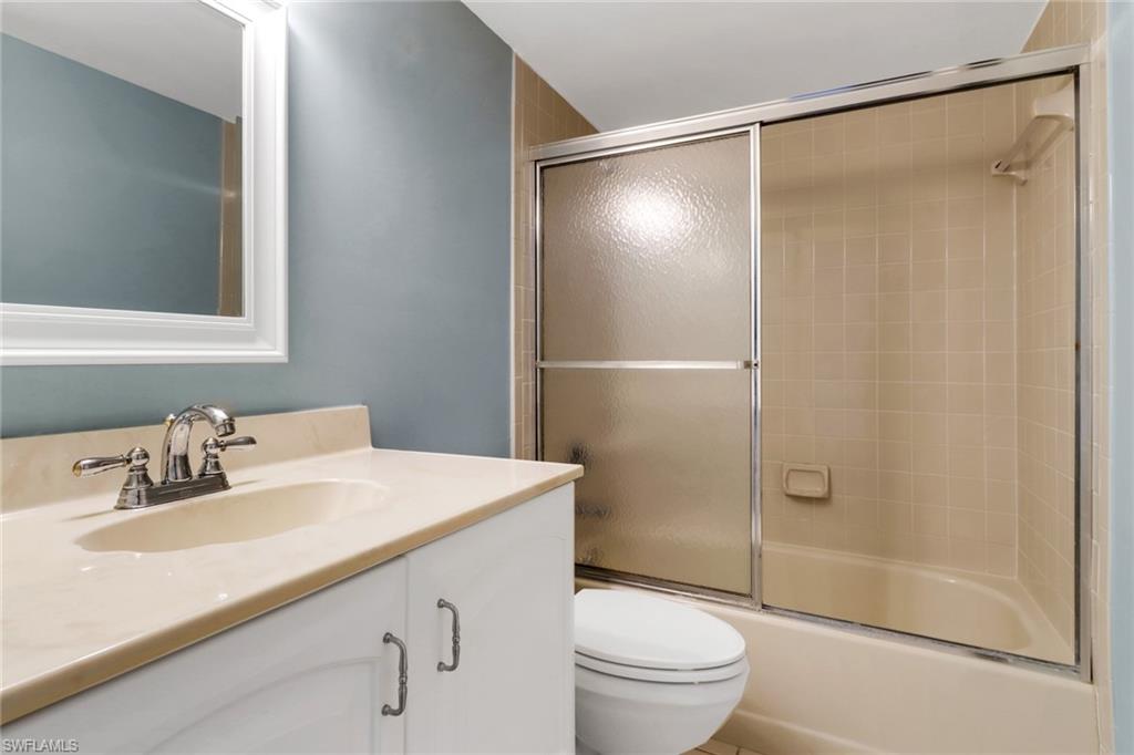4556 Andover Way, Unit E106 Naples, FL 34112 - Photo 23 of 41 Full bathroom with vanity and combined bath / shower with glass door