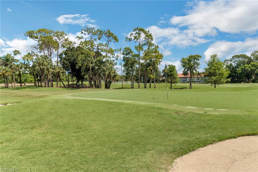 4556 Andover Way, Unit E106 Naples, FL 34112 - Photo 28 of 41 View of property's community with view of golf course, a lawn, and a putting green