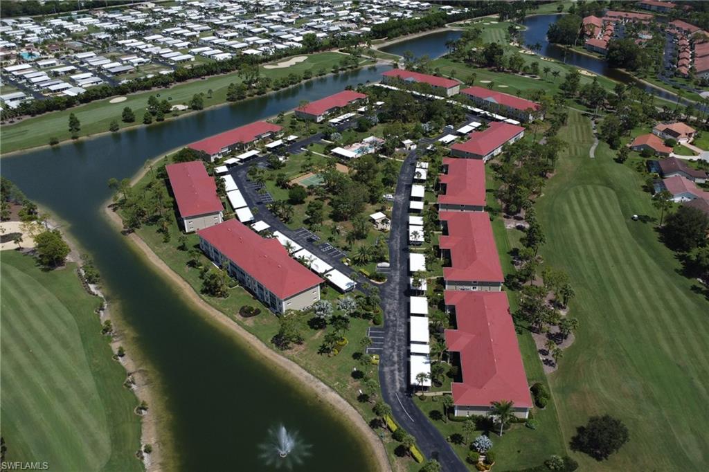 4556 Andover Way, Unit E106 Naples, FL 34112 - Photo 35 of 41 Aerial overview of property's location featuring a large body of water, nearby suburban area, and a golf course