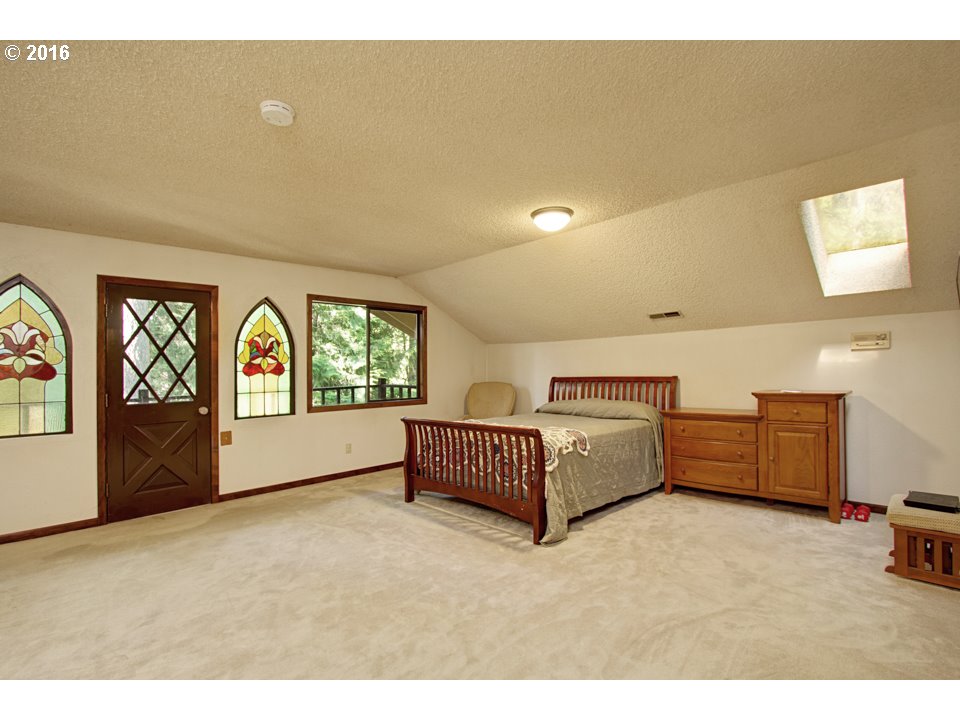 13333 Southeast Marsh Road Sandy, OR 97055 - Photo 10 of 23 a spacious bedroom with a bed and a large window