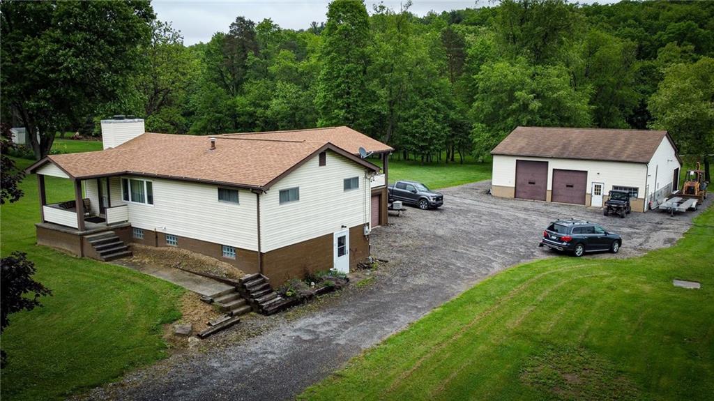 a view of a house with a yard and fence
