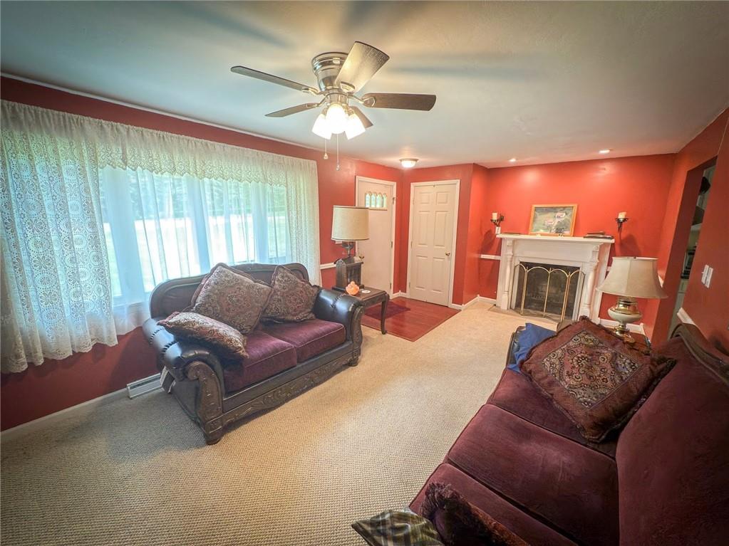 829 Saxonburg Road Butler, PA 16002 - Photo 6 of 49 a living room with furniture a fireplace and a large window