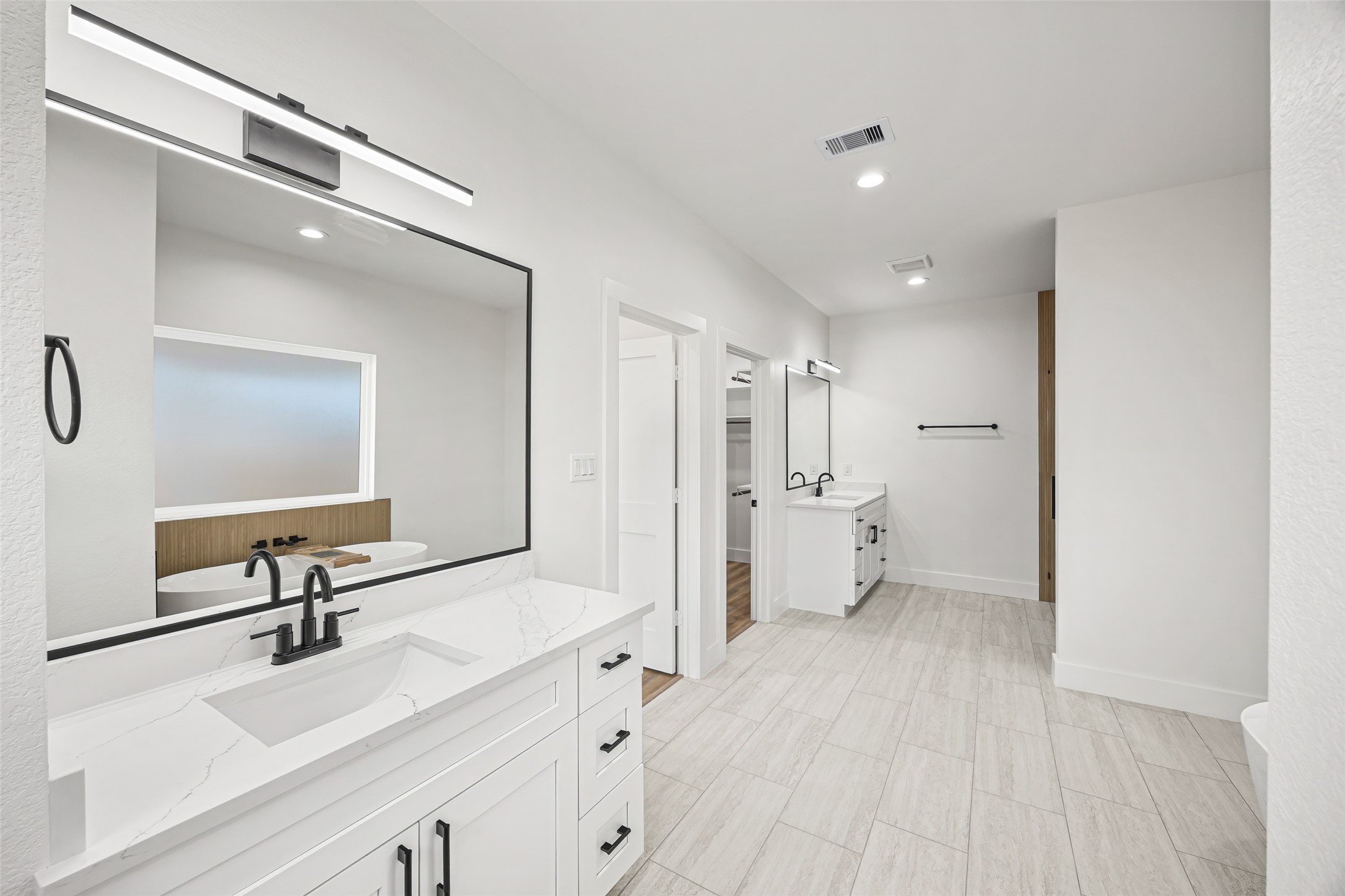 1807 Waco Street Dayton, TX 77535 - Photo 15 of 26 Dual quartz vanities with modern mirrors and designer lighting.
