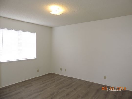 409 South Sunset Street Ridgecrest, CA 93555 - Photo 8 of 19 an empty room with a window