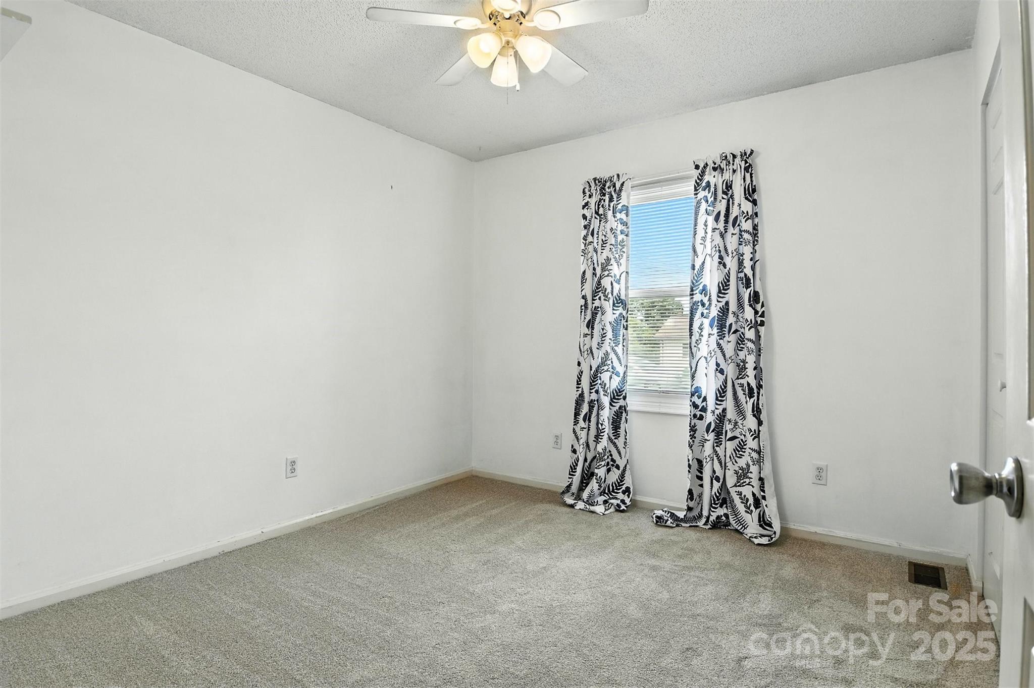 952 30th Street Northeast Conover, NC 28613 - Photo 24 of 36 an empty room with a window and a chandelier fan
