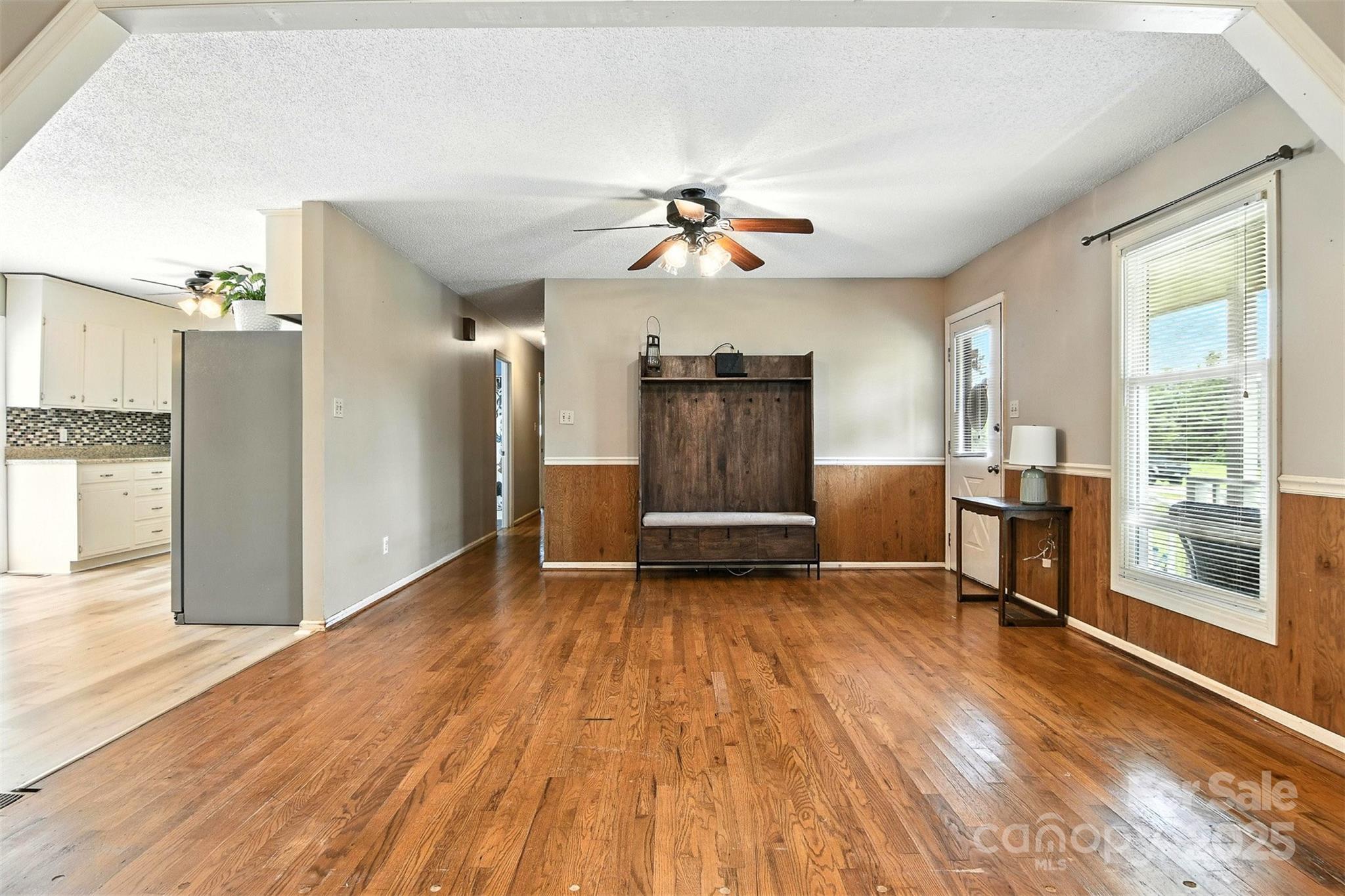 952 30th Street Northeast Conover, NC 28613 - Photo 8 of 36 a view of a livingroom with wooden floor and a ceiling fan