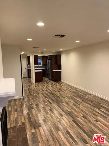 a open kitchen with kitchen island a sink stainless steel appliances and cabinets