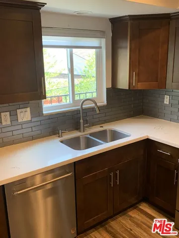 a kitchen with a sink and cabinets