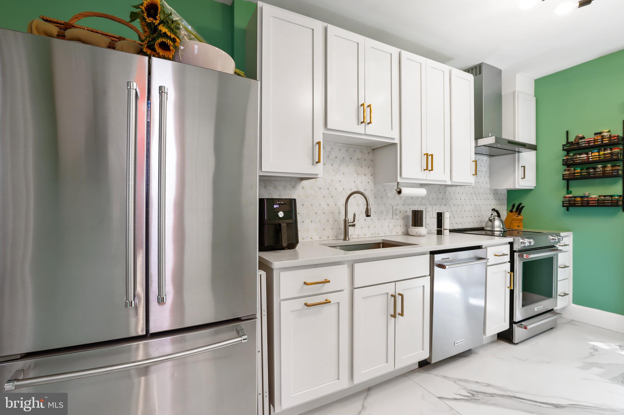 1215 33rd Street Northwest Washington, DC 20007 - Photo 11 of 37 a kitchen with white cabinets and white appliances
