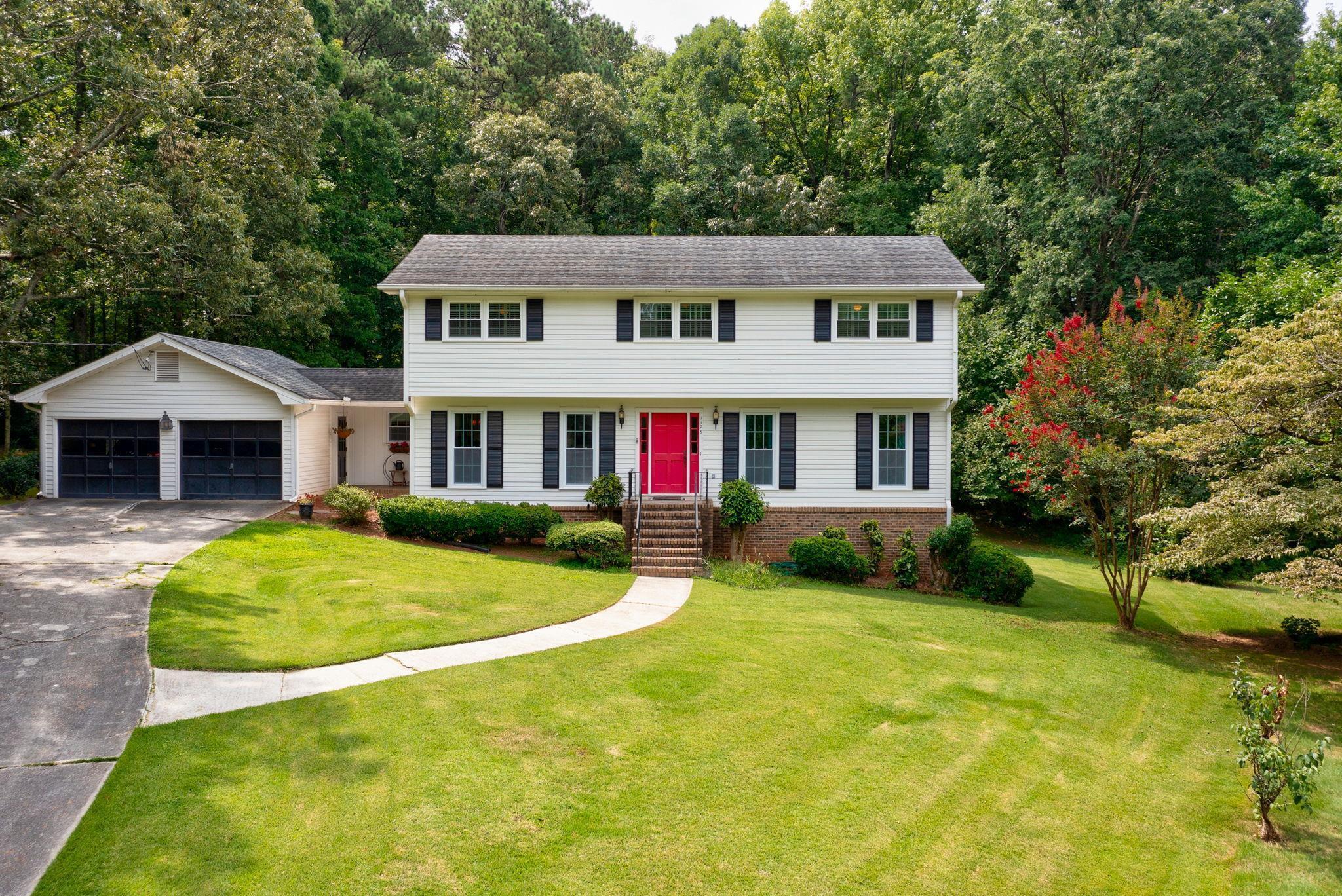 a front view of house with yard and green space