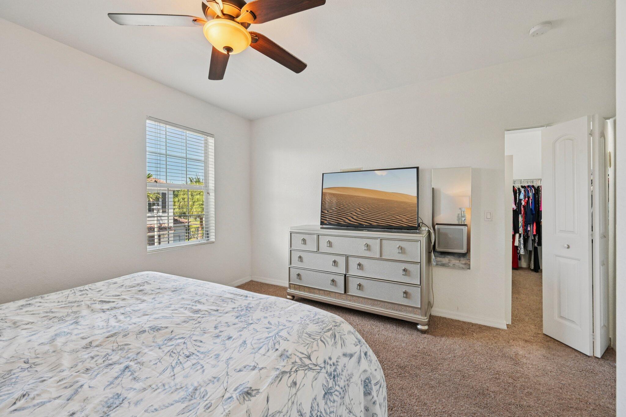482 Graham Place Boynton Beach, FL 33435 - Photo 16 of 39 a bedroom with a bed and a flat screen tv