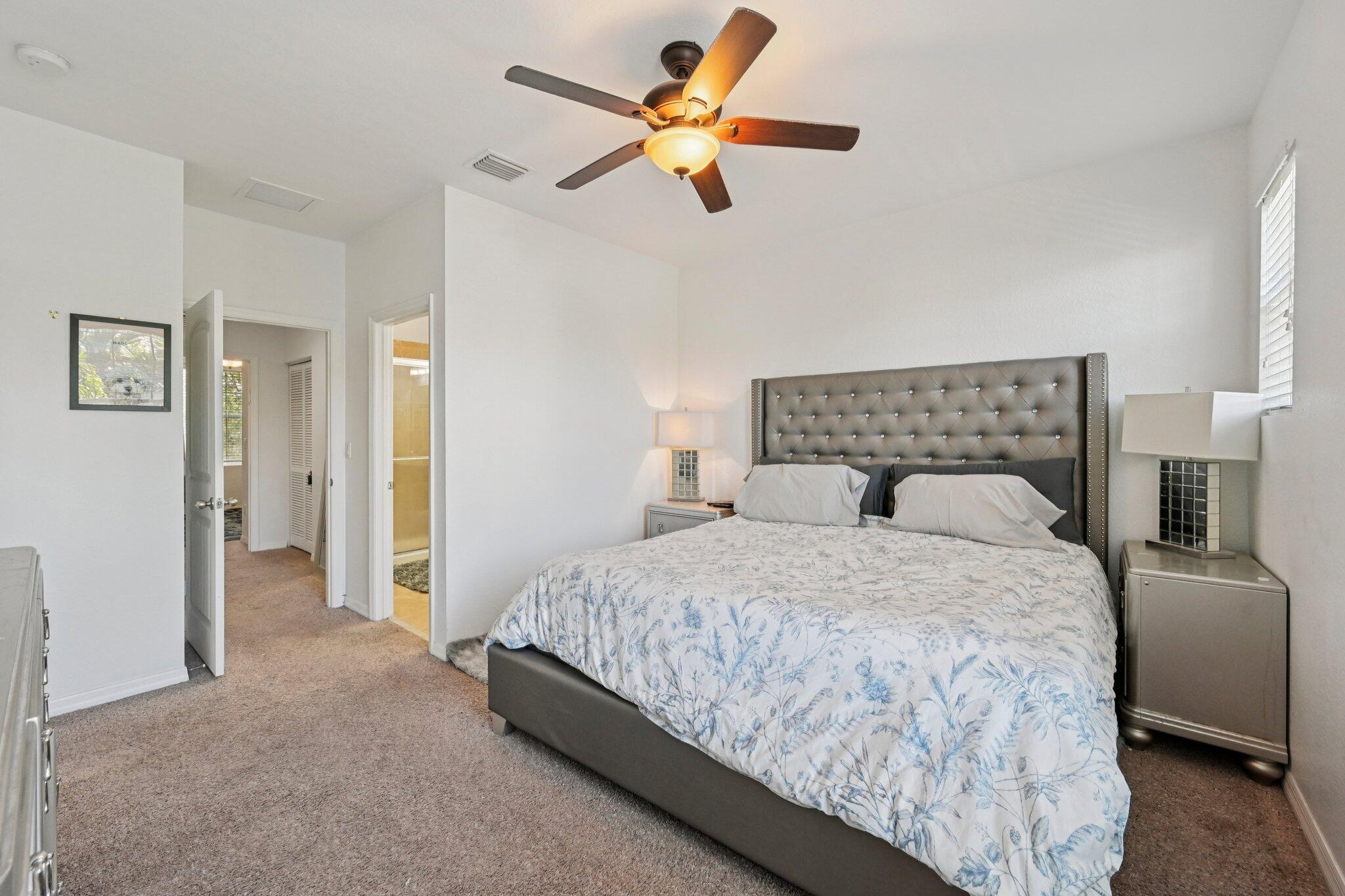 482 Graham Place Boynton Beach, FL 33435 - Photo 17 of 39 a bedroom with a bed and a chandelier