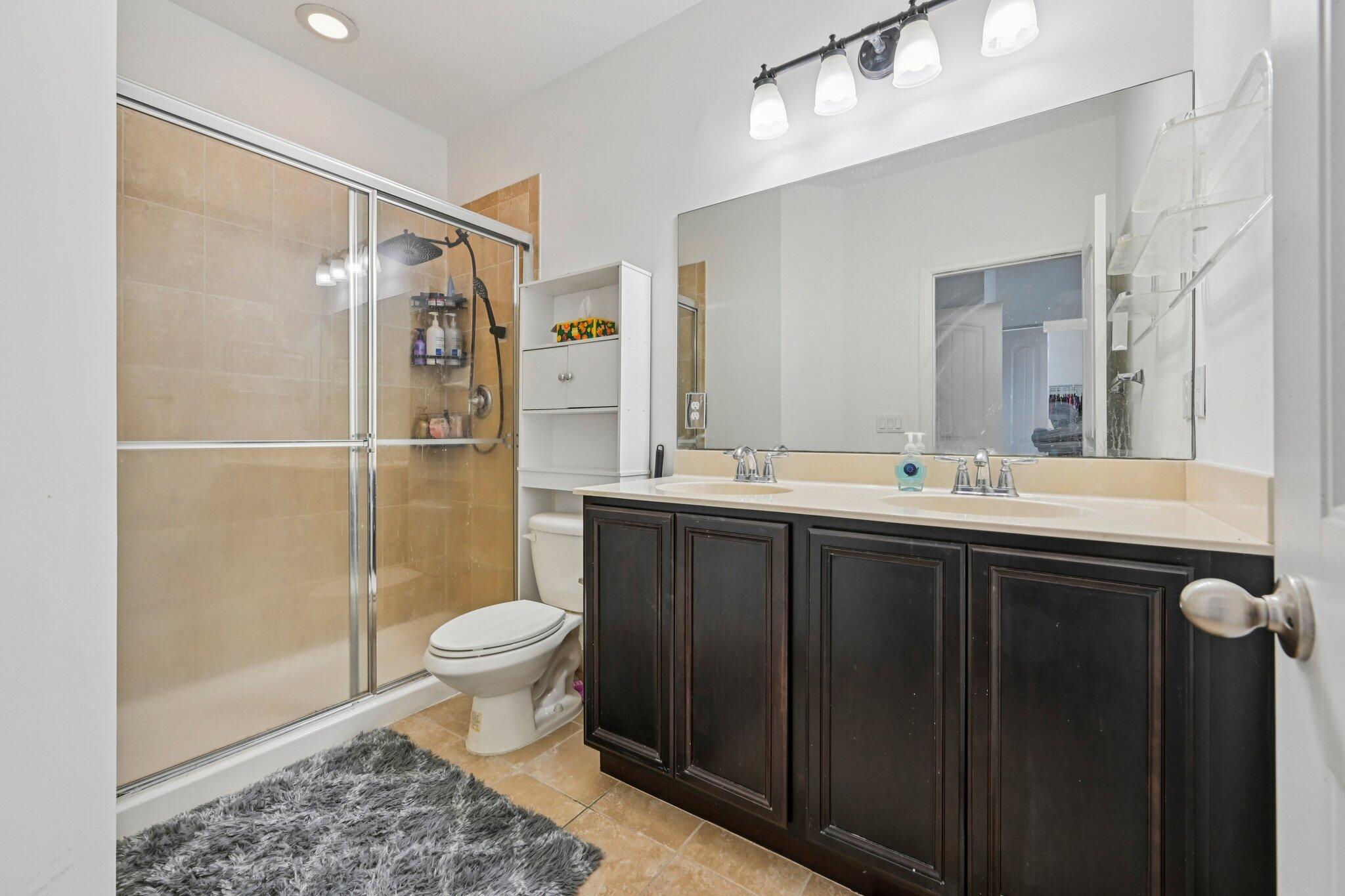 482 Graham Place Boynton Beach, FL 33435 - Photo 19 of 39 a bathroom with a sink a toilet a mirror and shower