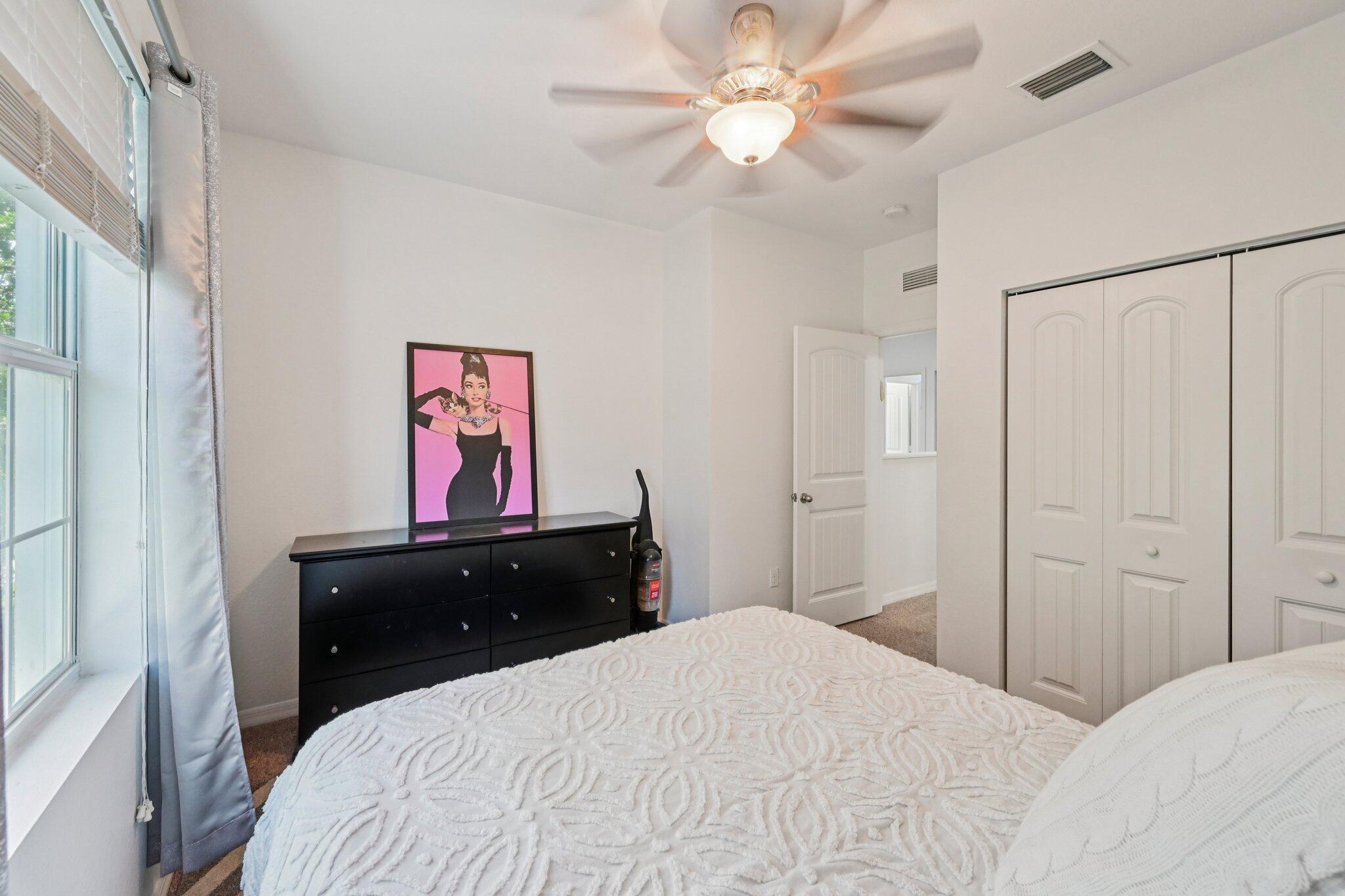 482 Graham Place Boynton Beach, FL 33435 - Photo 24 of 39 a bedroom with a bed and a dresser