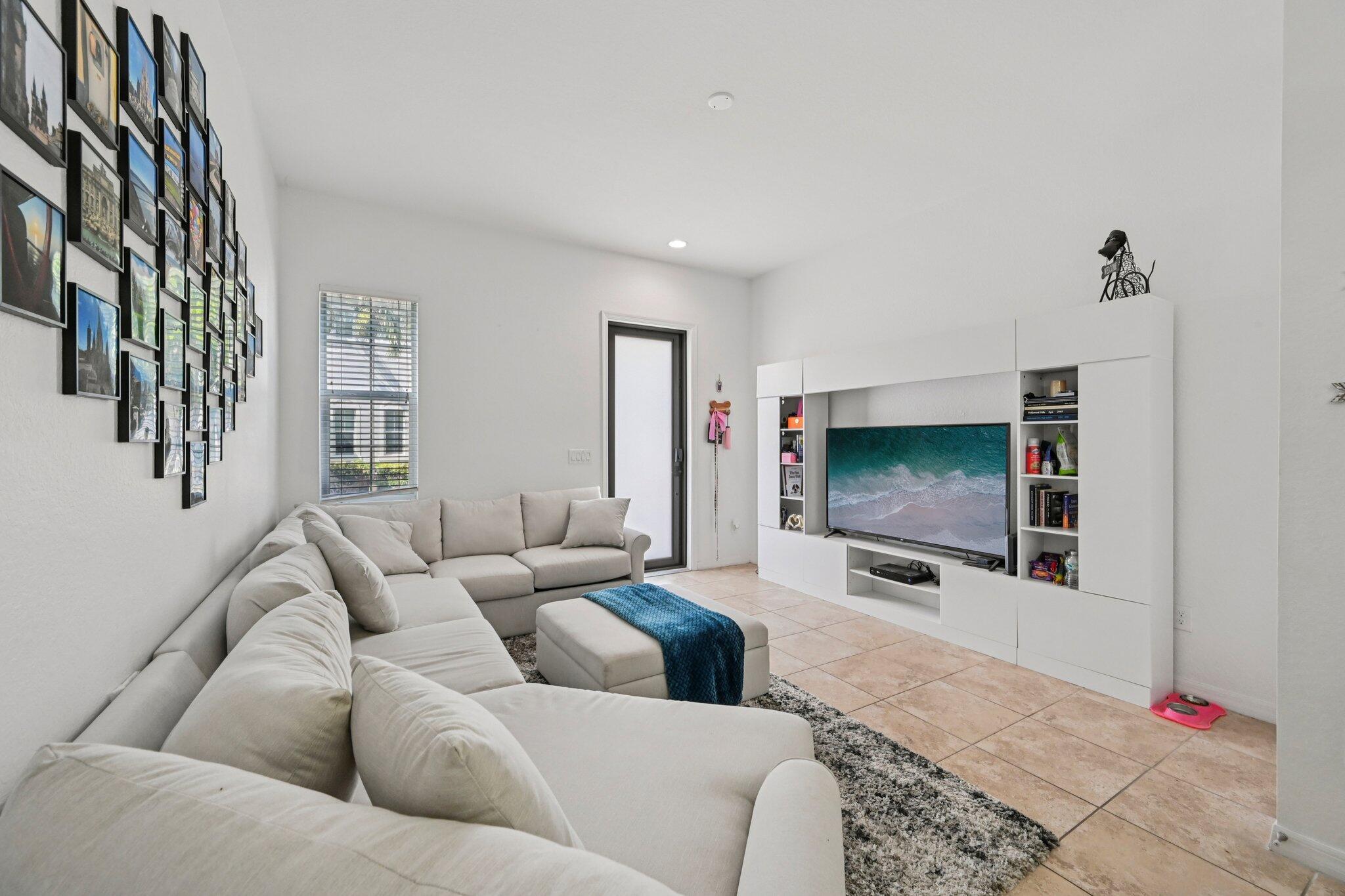 482 Graham Place Boynton Beach, FL 33435 - Photo 3 of 39 a living room with furniture and a flat screen tv
