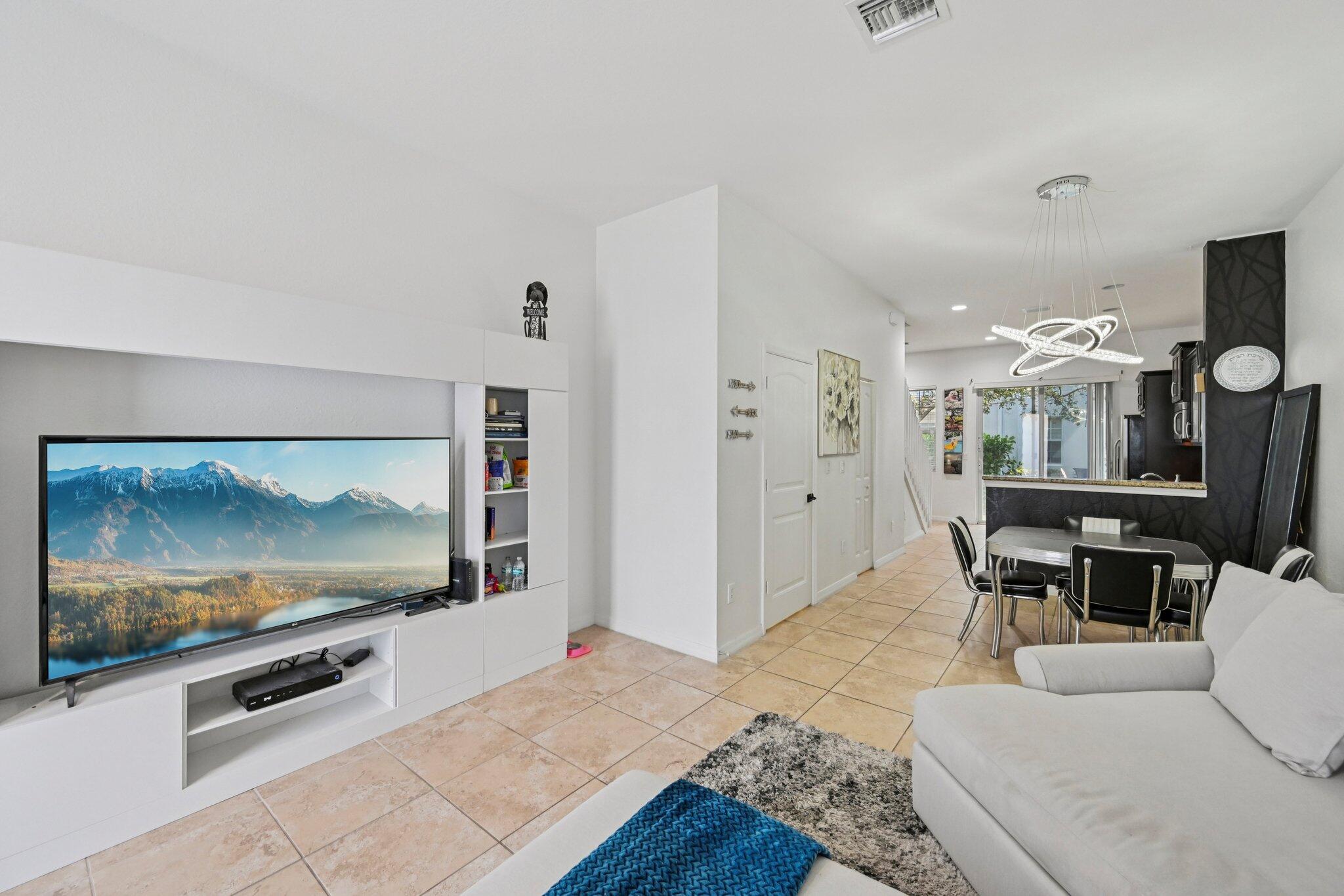 482 Graham Place Boynton Beach, FL 33435 - Photo 5 of 39 a living room with furniture and a flat screen tv