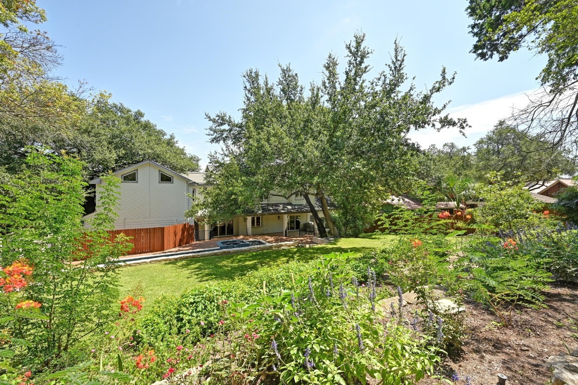 4207 Bennedict Lane Austin, TX 78746 - Photo 12 of 27 a backyard of a house with table and chairs