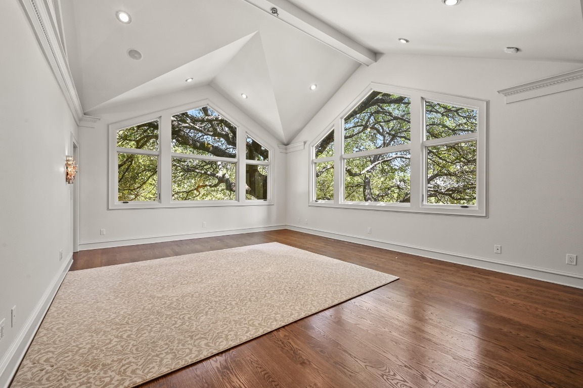 4207 Bennedict Lane Austin, TX 78746 - Photo 13 of 27 an empty room with wooden floor large windows and outdoor view