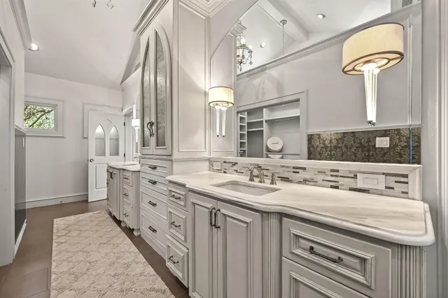 a bathroom with a shower and a sink a mirror