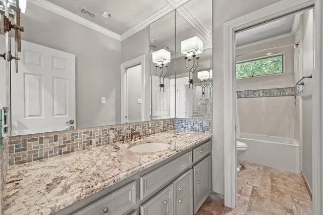 a living room with furniture and a book shelf