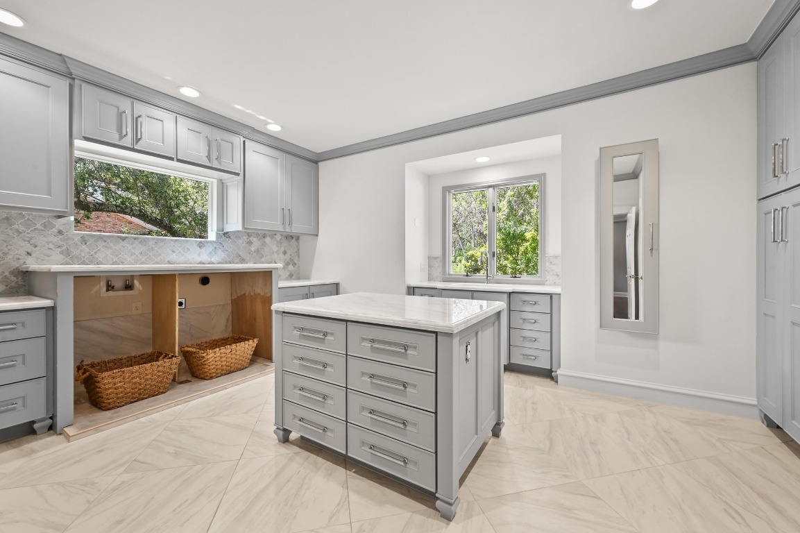 4207 Bennedict Lane Austin, TX 78746 - Photo 21 of 27 a kitchen with a stove a sink and a window