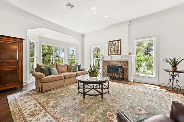 a living room with furniture a fireplace and a table