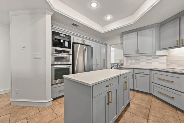 a kitchen with a sink window and cabinets