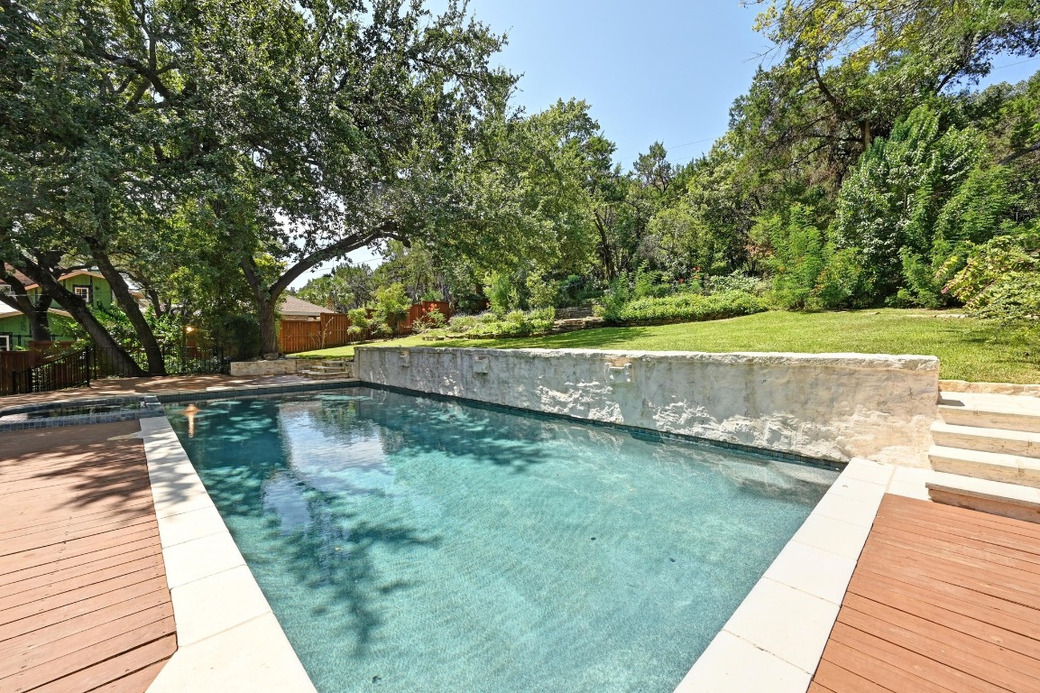 4207 Bennedict Lane Austin, TX 78746 - Photo 10 of 27 a view of a swimming pool with a yard